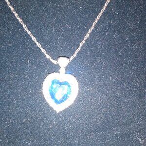 Silver tone heart shaped pendent necklace with Rhinestones & center blue stone.